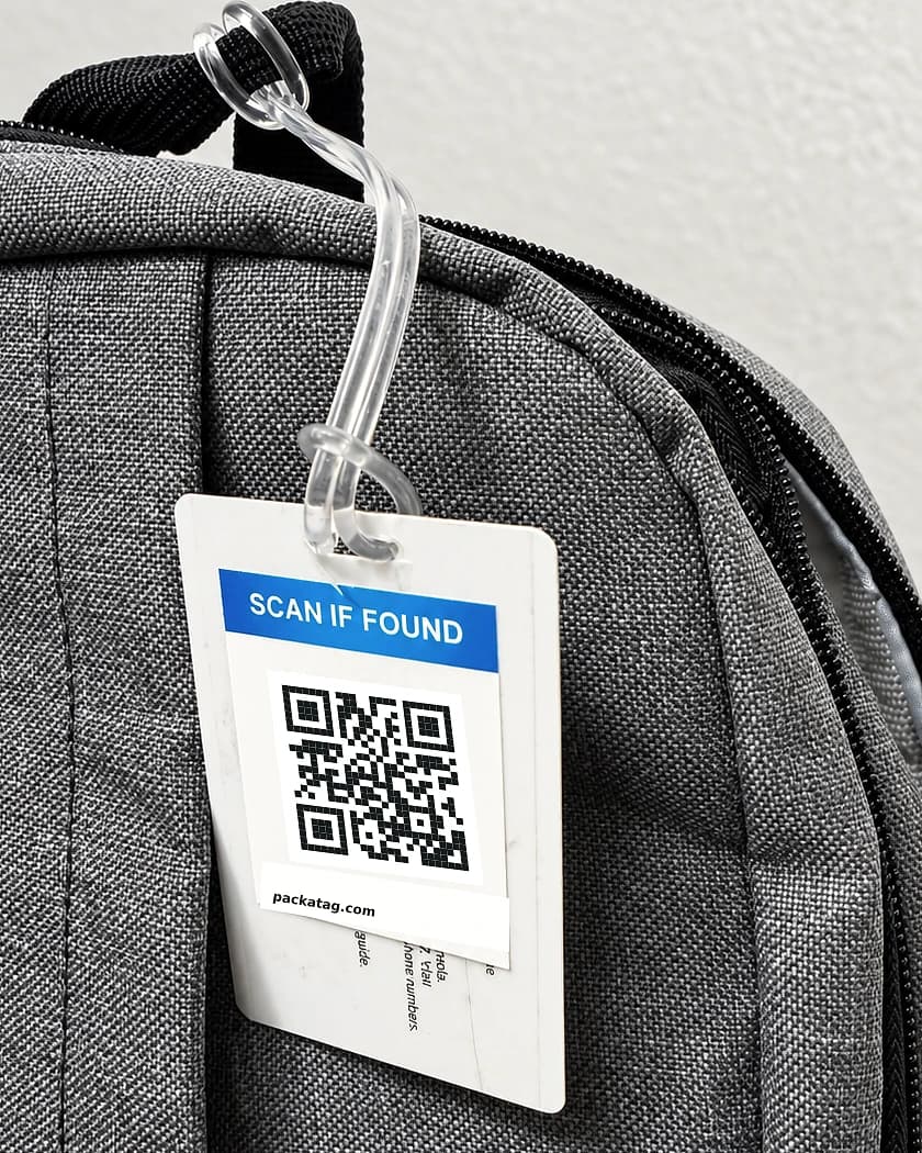 PackaTag QR recovery tag attached to a laptop bag